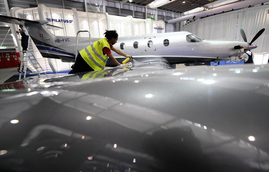 An employee cleans a PC-12 model of the Swiss aircraft manufacturer Pilatus during the press day of the 8th Annual European Business Aviation Convention & Exhibition on May 19, 2008, in Geneva's International Airport. (Fabrice Coffrini/AFP via Getty Images)