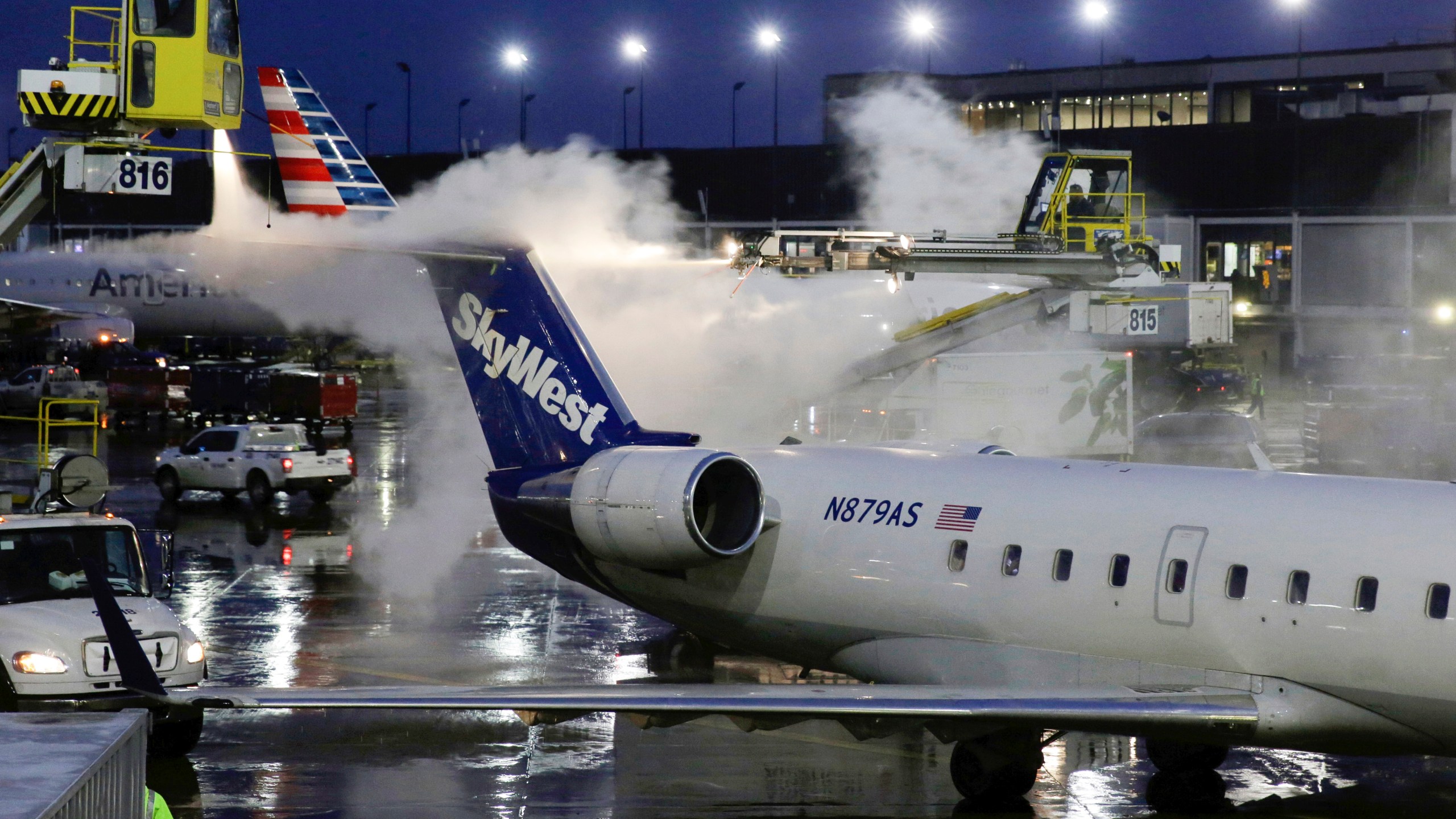 A deicing agent is applied to a SkyWest airplane before its takeoff from O'Hare International Airport on Jan. 18, 2019, in this file photo. (AP Photo/Kiichiro Sato, File)