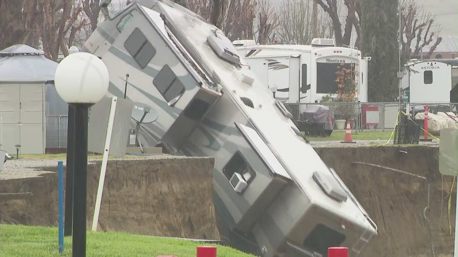 An RV tumbling off an embankment and into a river in Castaic on Feb. 25, 2023. (KTLA)