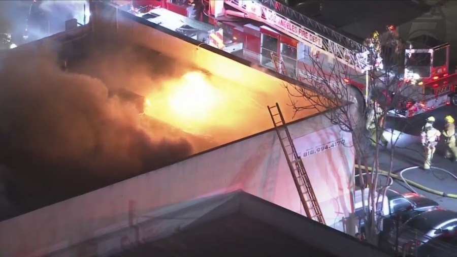 Crews tackled a large fire consuming a commercial building in Van Nuys on Feb. 16, 2023. (KTLA)