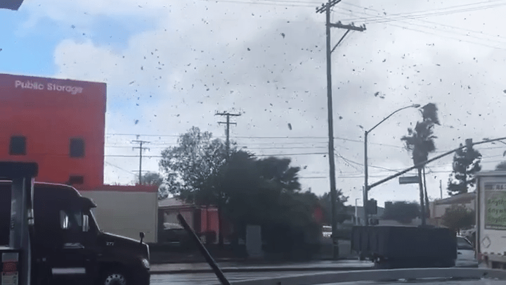 Debris swirls during a reported tornado in Montebello on March 22, 2023. (Meliza Madrid)