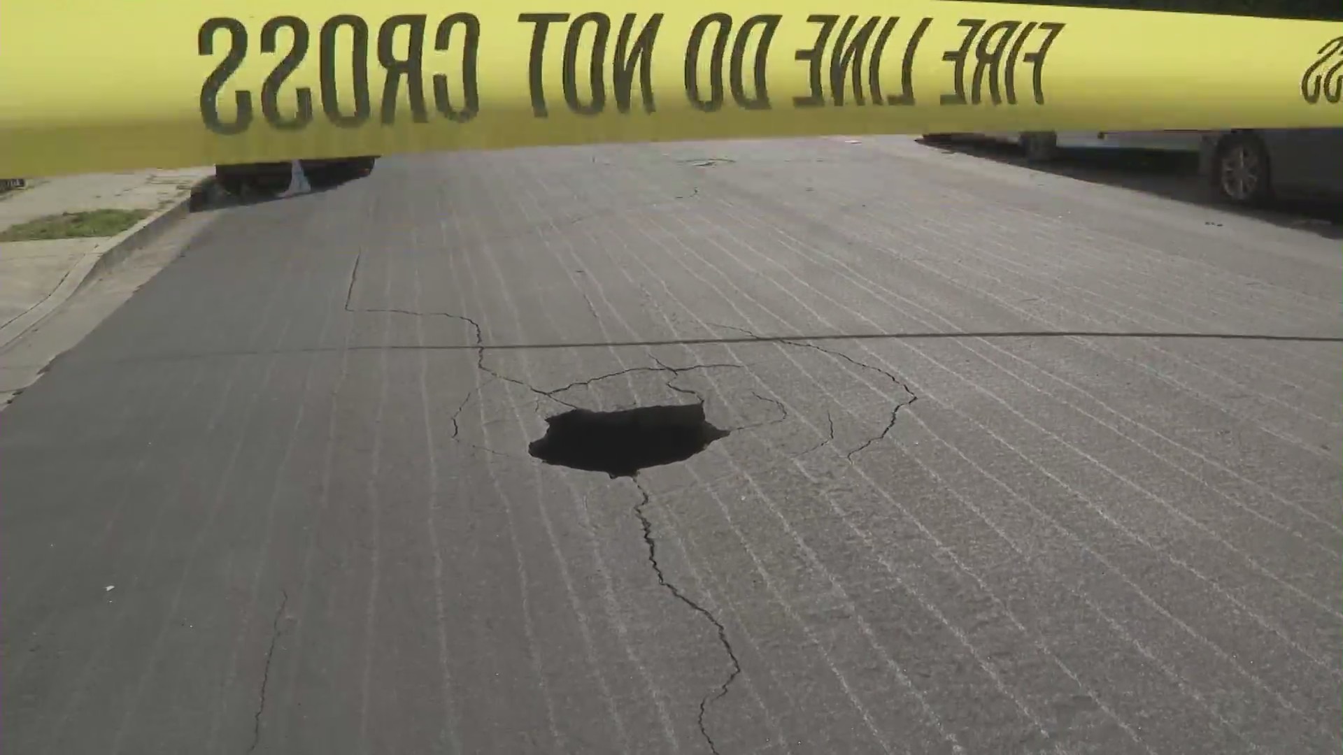 A sinkhole in Pico-Union, as shown on Feb. 28, 2023, is about 10 feet deep, police say. (KTLA)