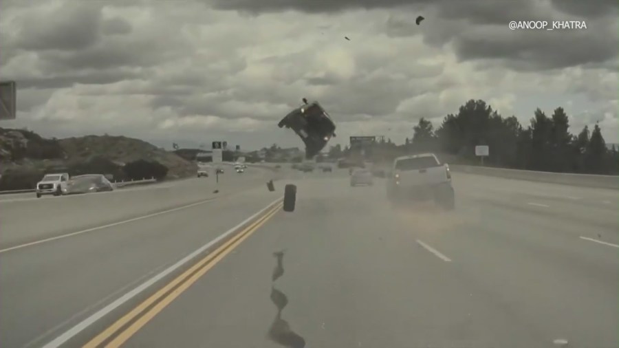 Car launched into midair spin on by loose tire on 118 Freeway