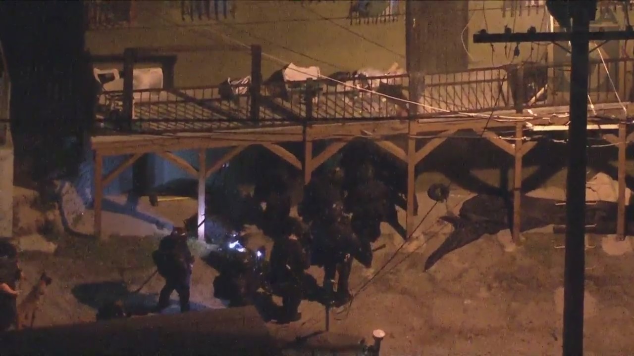 An LAPD SWAT team moves in on the location of a suspect who engaged in a shootout with police on March 8, 2023. (KTLA)