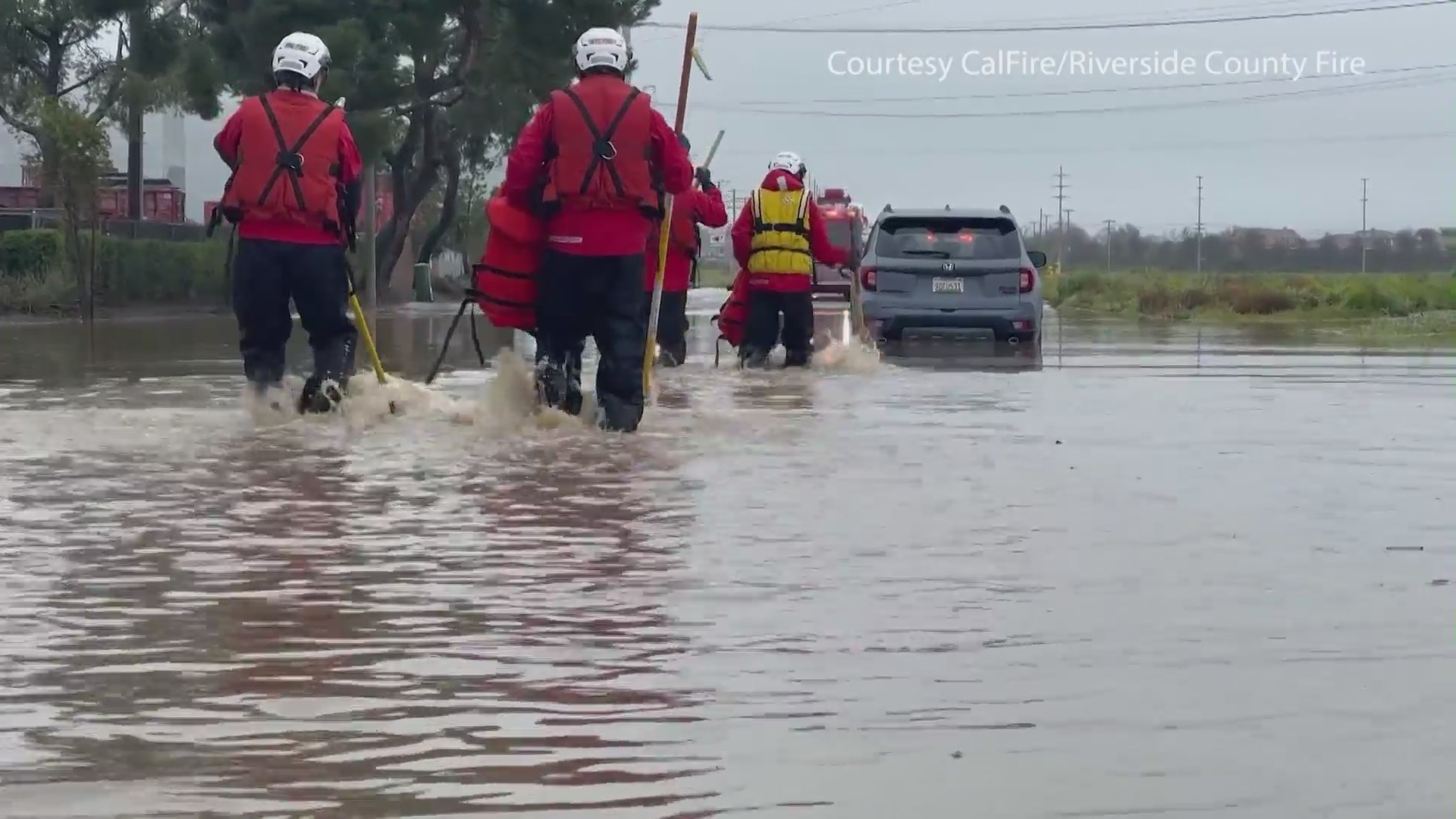 Driver rescued from flooded road in the Inland Empire. (CalFire/Riverside County Fire.)