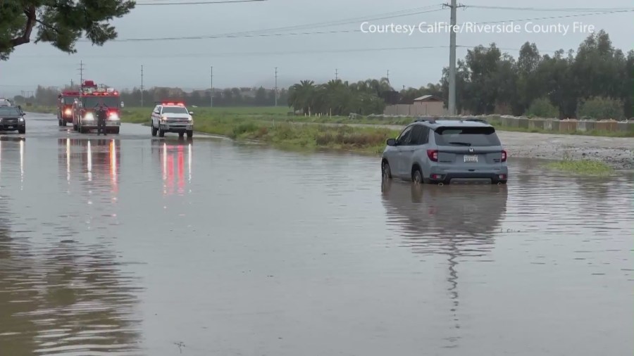 Driver traveling through completely flooded road in the Inland Empire. (CalFire/Riverside County Fire.)