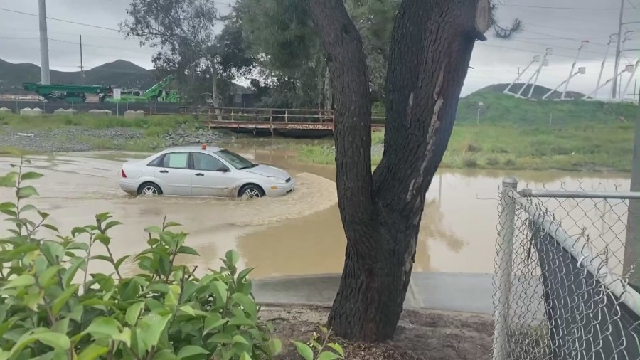 Driver traveling through completely flooded road in the Menifee. (KTLA)