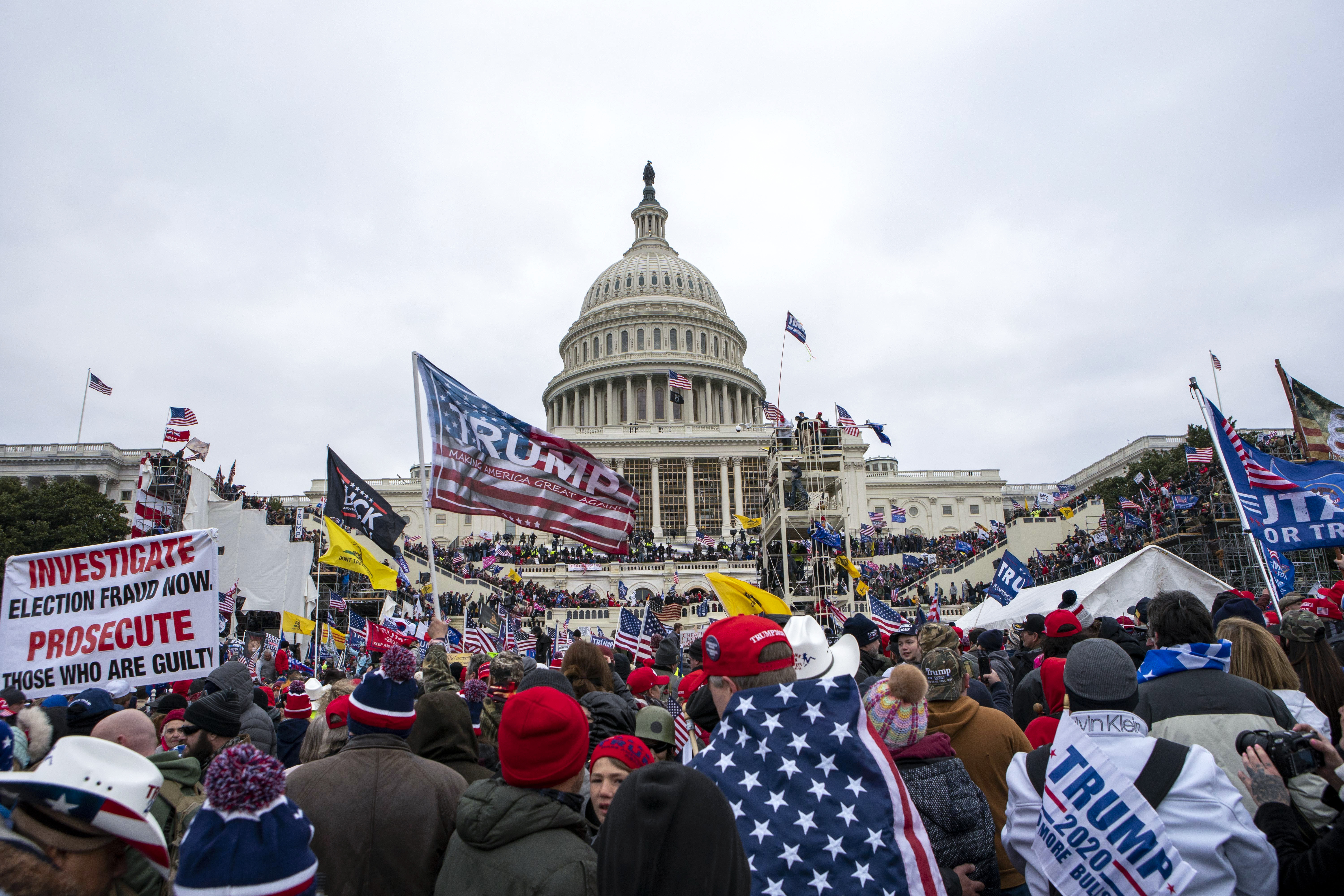 Insurrectionists loyal to President Donald Trump storm the U.S. Capitol in Washington on Jan. 6, 2021. A U.S. Capitol police officer who tried to help a Virginia fisherman avoid criminal charges for storming the building his law enforcement colleagues defended was sentenced on Thursday, April 13, to two years of probation and four months of home detention. Michael Angelo Riley, a 25-year police veteran, was on duty when a mob attacked the Capitol on Jan. 6, 2021, injuring more than 100 officers. (AP Photo/Jose Luis Magana, File)