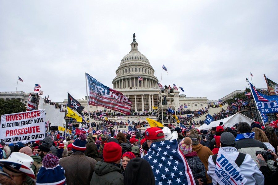 Insurrectionists loyal to President Donald Trump storm the U.S. Capitol in Washington on Jan. 6, 2021. A U.S. Capitol police officer who tried to help a Virginia fisherman avoid criminal charges for storming the building his law enforcement colleagues defended was sentenced on Thursday, April 13, to two years of probation and four months of home detention. Michael Angelo Riley, a 25-year police veteran, was on duty when a mob attacked the Capitol on Jan. 6, 2021, injuring more than 100 officers. (AP Photo/Jose Luis Magana, File)