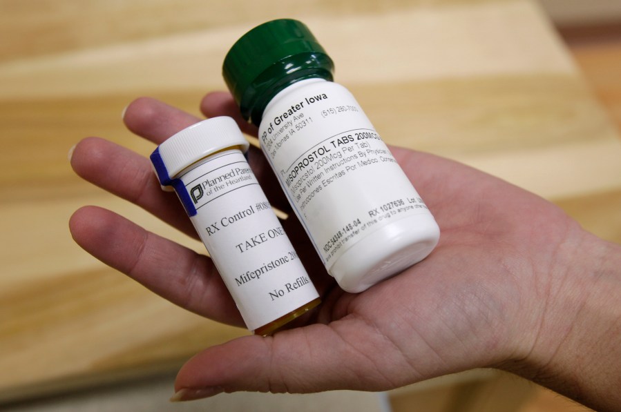 FILE - Bottles of abortion pills mifepristone, left, and misoprostol, right, at a clinic in Des Moines, Iowa, Sept. 22, 2010. A federal appeals court has preserved access to an abortion drug for now but under tighter rules that would allow the drug only to be dispensed up to seven weeks, not 10, and not by mail. (AP Photo/Charlie Neibergall, File)