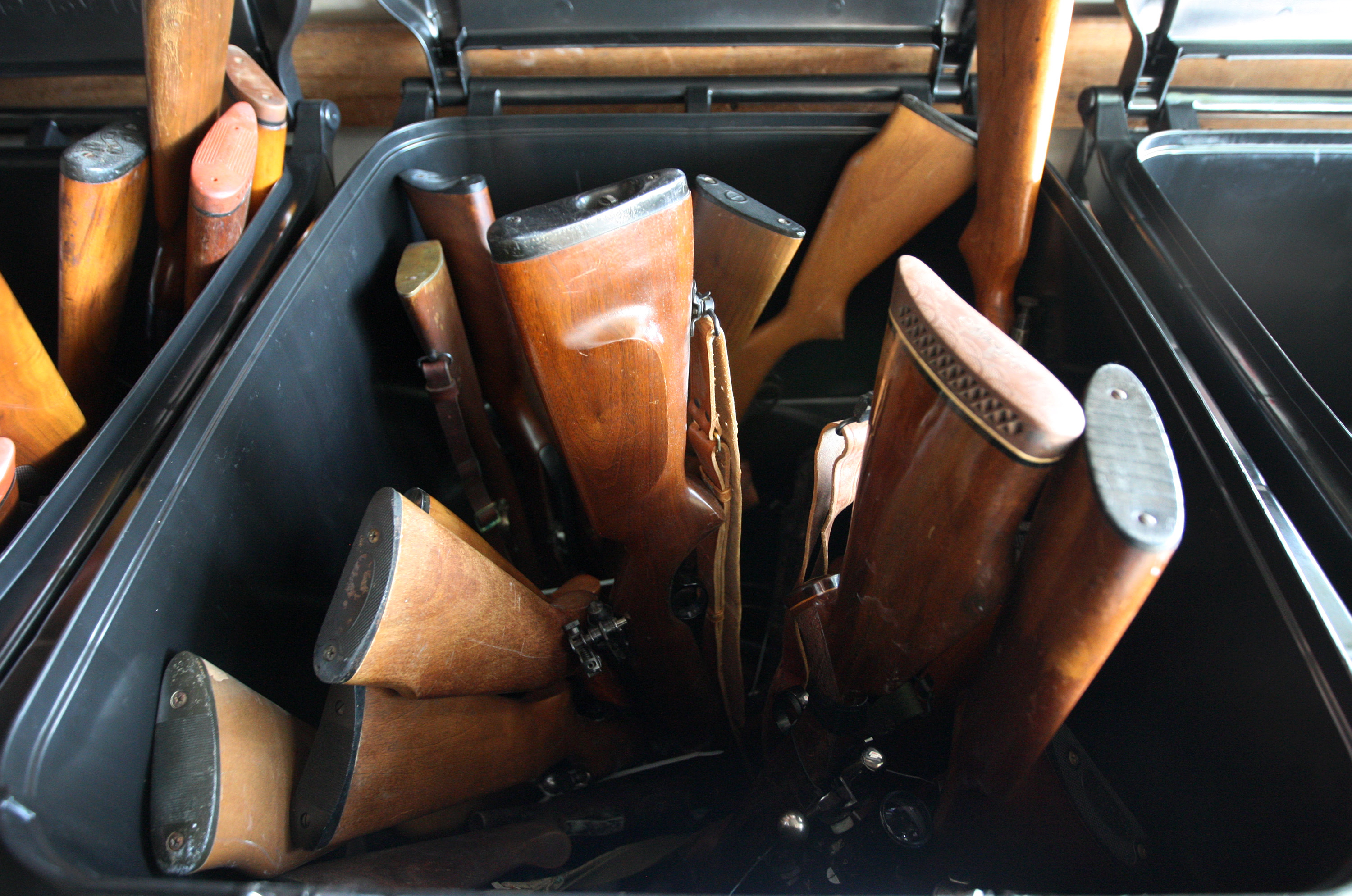 Surrendered rifles and shotguns are stacked in bins at a gun buyback event in Los Angeles.