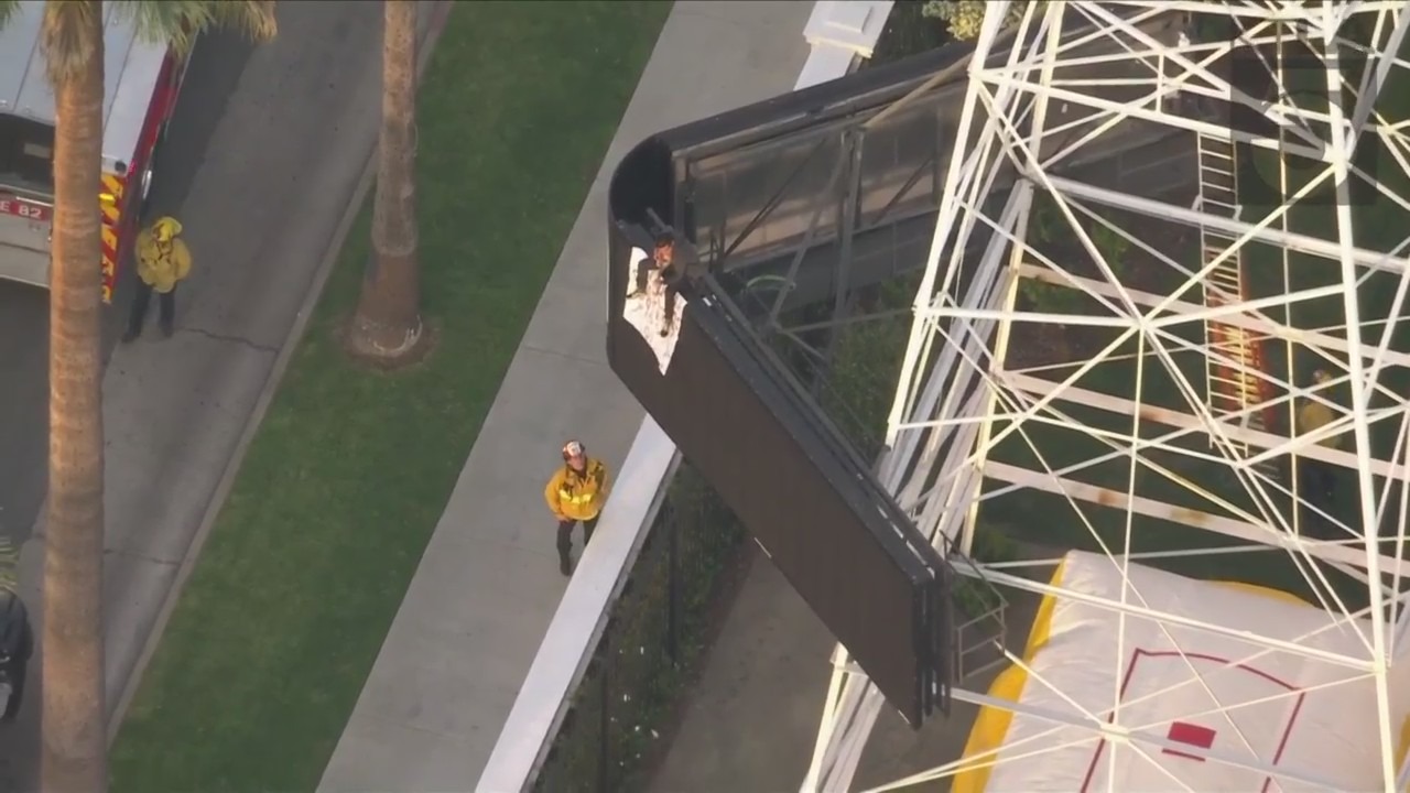 A man was seen climbing the KTLA 5 radio tower in Hollywood while holding a sign that read, “Free Billie Eilish” as authorities worked to remove him on April 25, 2023. (KTLA)