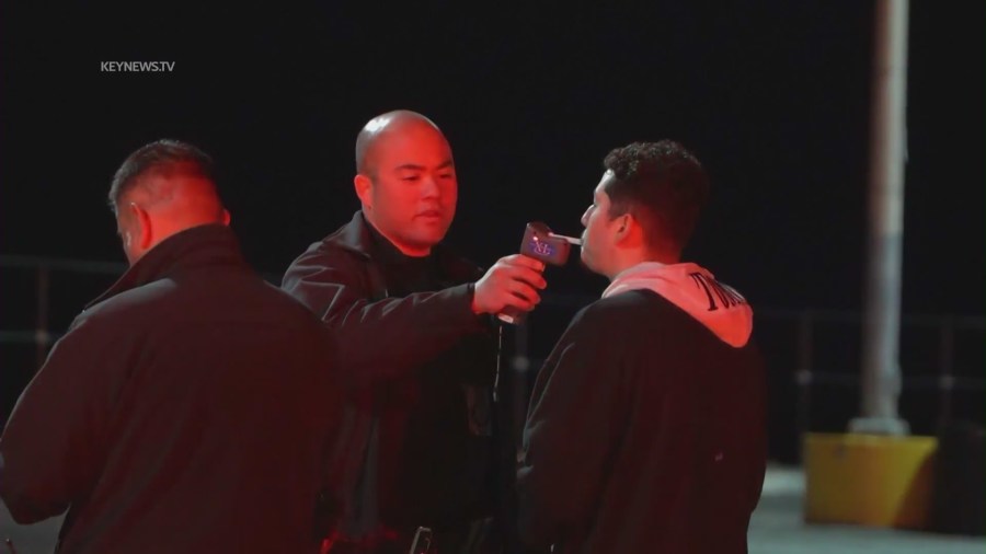 The 21-year-old suspected DUI driver being taken into custody following a deadly crash in Pacific Palisades on April 8, 2023. (KeyNews.TV)