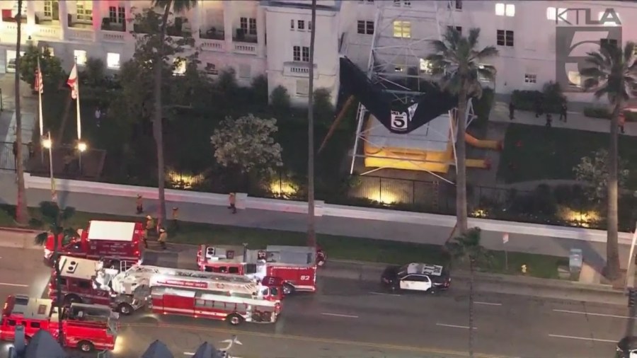 A man was seen climbing the KTLA 5 radio tower in Hollywood while holding a sign that read, “Free Billie Eilish” as authorities worked to remove him on April 25, 2023. (KTLA)