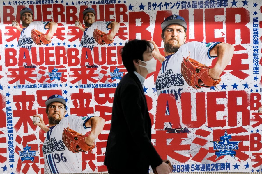 Posters of Trevor Bauer who's pitching for the Yokohama BayStars are placed at the pathway of a train station on Tuesday, May 2, 2023, in Yokohama near Tokyo. Bauer will pitch his first official game for the Yokohama DeNA BayStars on Wednesday and, to promote the start, a local department store is to unveil a seven-story poster of the former Cy Young winner on the building's facade. (AP Photo/Eugene Hoshiko)