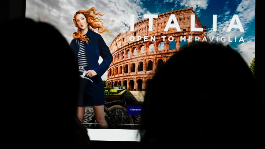 People watch on a computer monitor the latest Italian Ministry of Tourism nine-million-euro campaign showing Botticelli's Venus depicted as a virtual influencer in Rome, Wednesday, May 3, 203. A nine-million-euro advertising campaign by Italy’s conservative government that has transformed “The Birth of Venus,” painted by Renaissance master Sandro Botticelli in Florence around 1485, into a virtual influencer has met with widespread derision. (AP Photo/Gregorio Borgia)