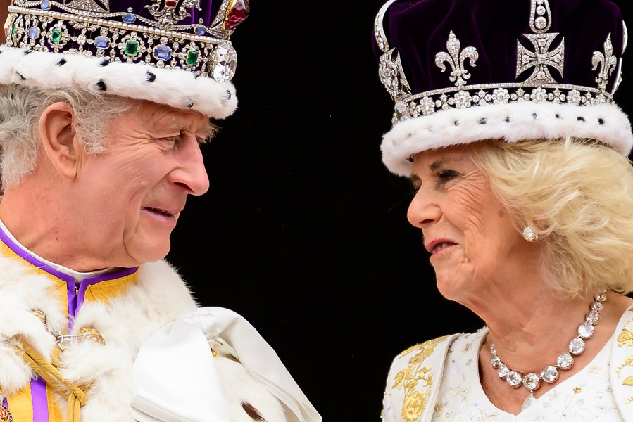 Britain's King Charles III and Queen Camilla look at each other as they stand on the balcony of the Buckingham Palace after their coronation, in London, Saturday, May 6, 2023. (Leon Neal/Pool Photo via AP)