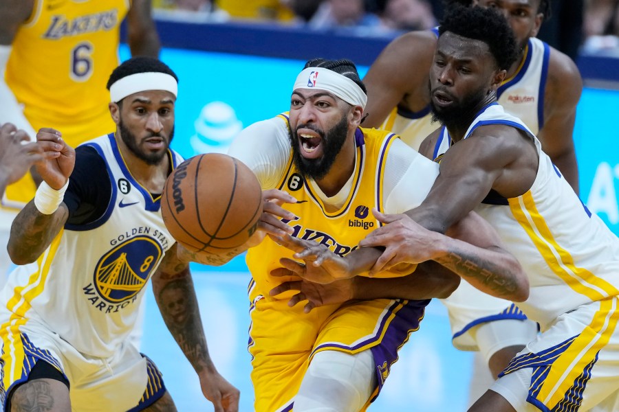 Los Angeles Lakers forward Anthony Davis, middle, reaches for the ball between Golden State Warriors guard Gary Payton II (8) and forward Andrew Wiggins during the first half of Game 5 of an NBA basketball second-round playoff series Wednesday, May 10, 2023, in San Francisco. (AP Photo/Godofredo A. Vásquez)