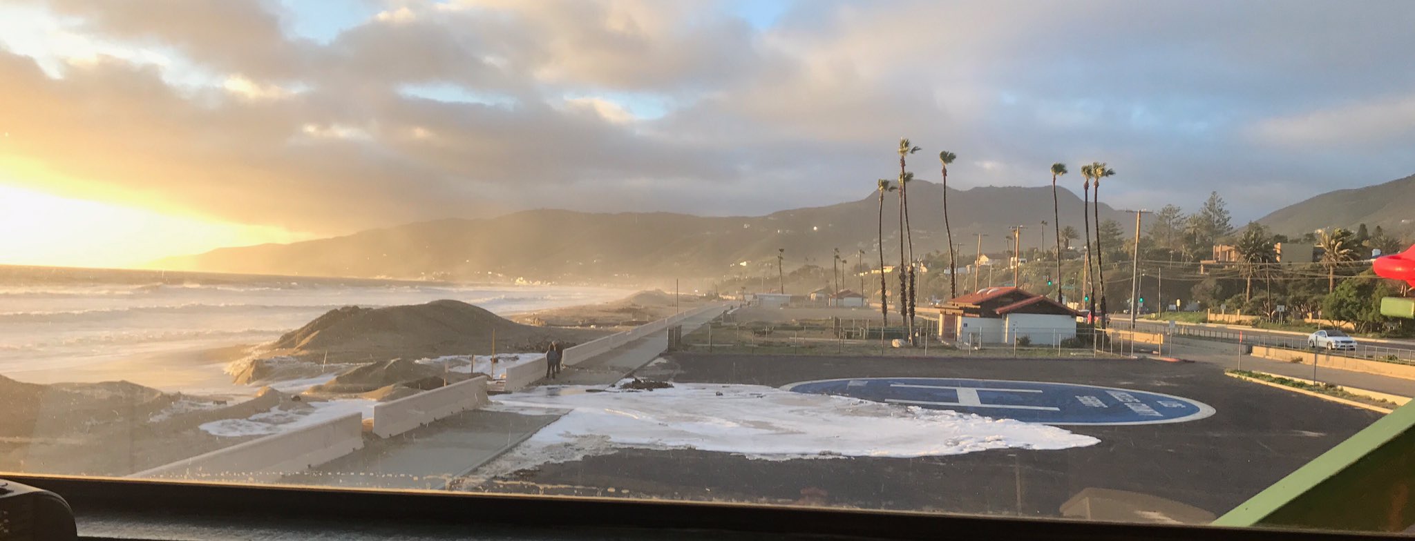 Coastal flooding, like that shown in this undated image of Zuma Beach walkways and a parking lot on the Malibu coast, is possible for the next few days. (National Weather Service)