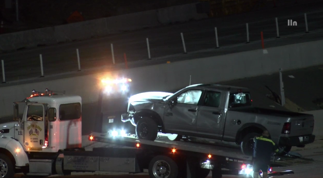 A truck with major damage is towed from the scene of a road-rage shooting and crash in Corona on April 30, 2023. (LOUDLABS)