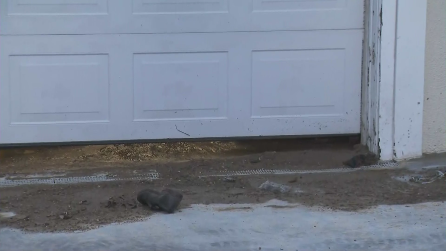 Mud is left behind under a garage after a sheared fire hydrant flooded a Sherman Oaks neighborhood on May 9, 2023. (KTLA)