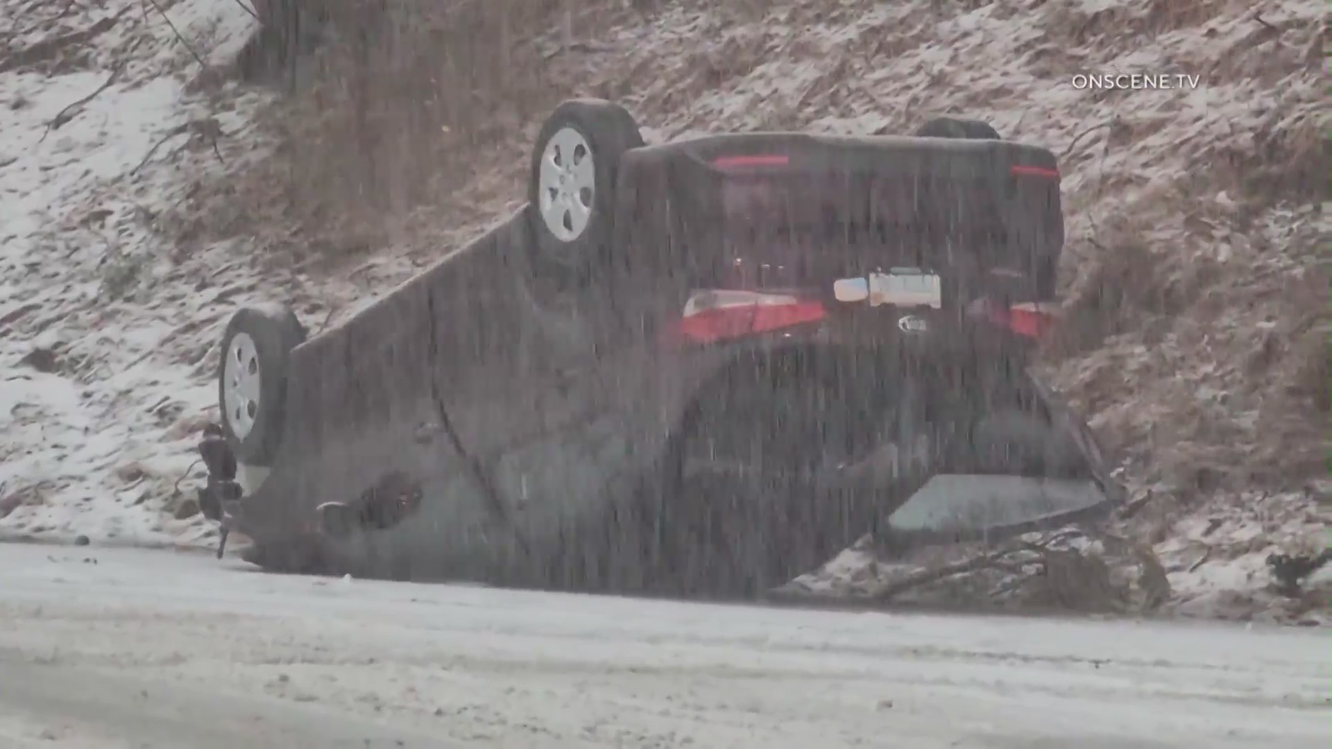 An overturned vehicle amid heavy snowfall blanketing Southern California mountains on May 4, 2023. (OnScene.TV)