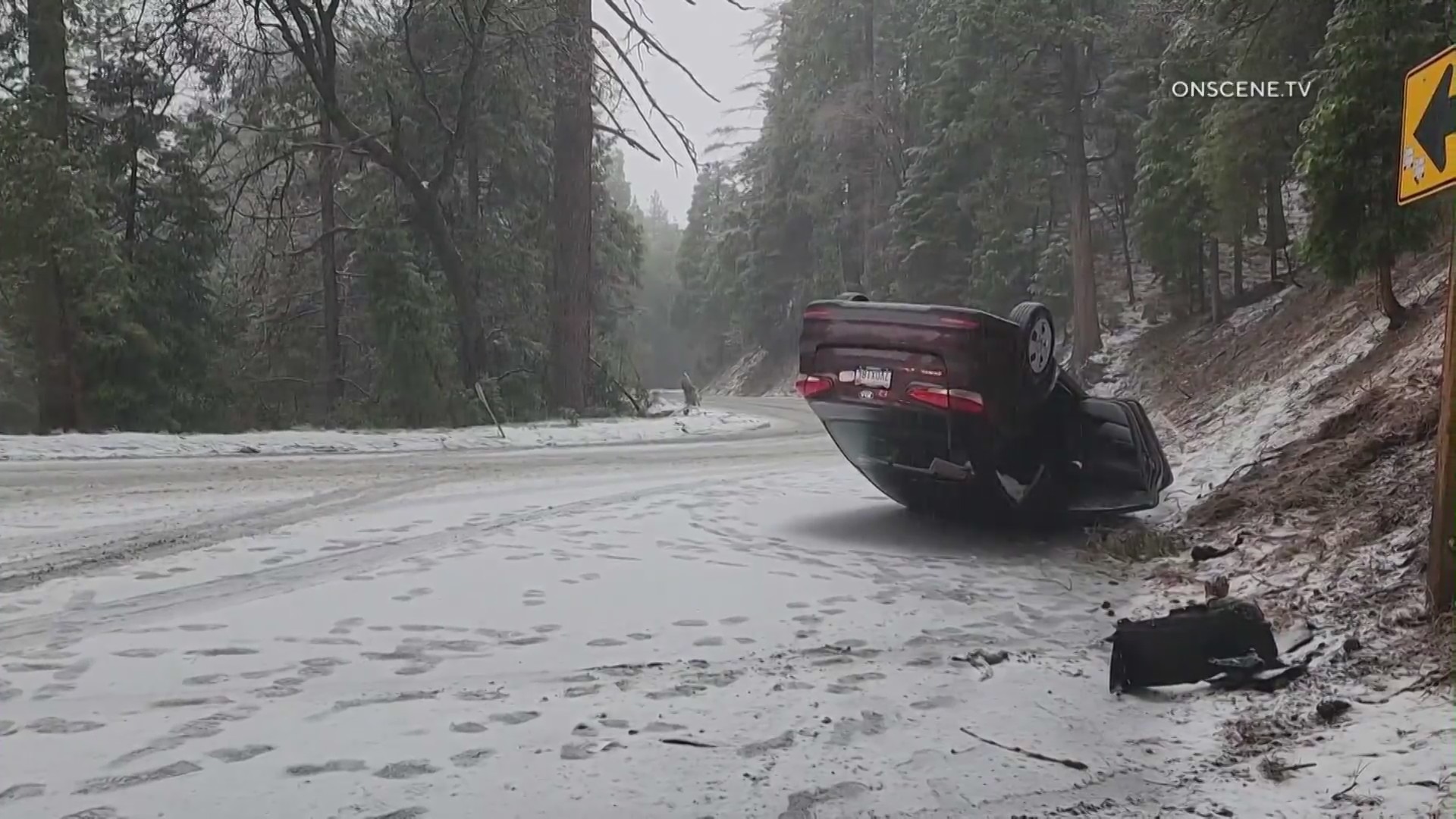 An overturned vehicle amid heavy snowfall blanketing Southern California mountains on May 4, 2023. (OnScene.TV)