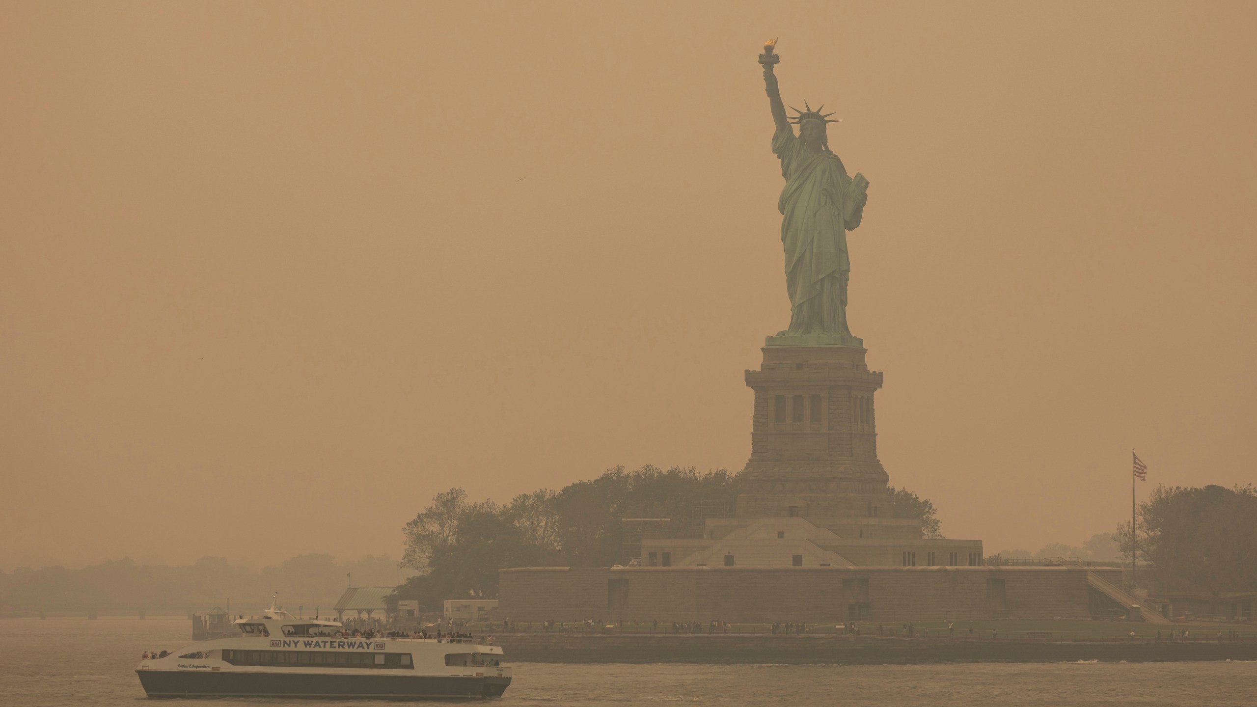 The Statue of Liberty, covered in a haze-filled sky, is photographed from the Staten Island Ferry, Wednesday, June 7, 2023, in New York. (AP Photo/Yuki Iwamura)