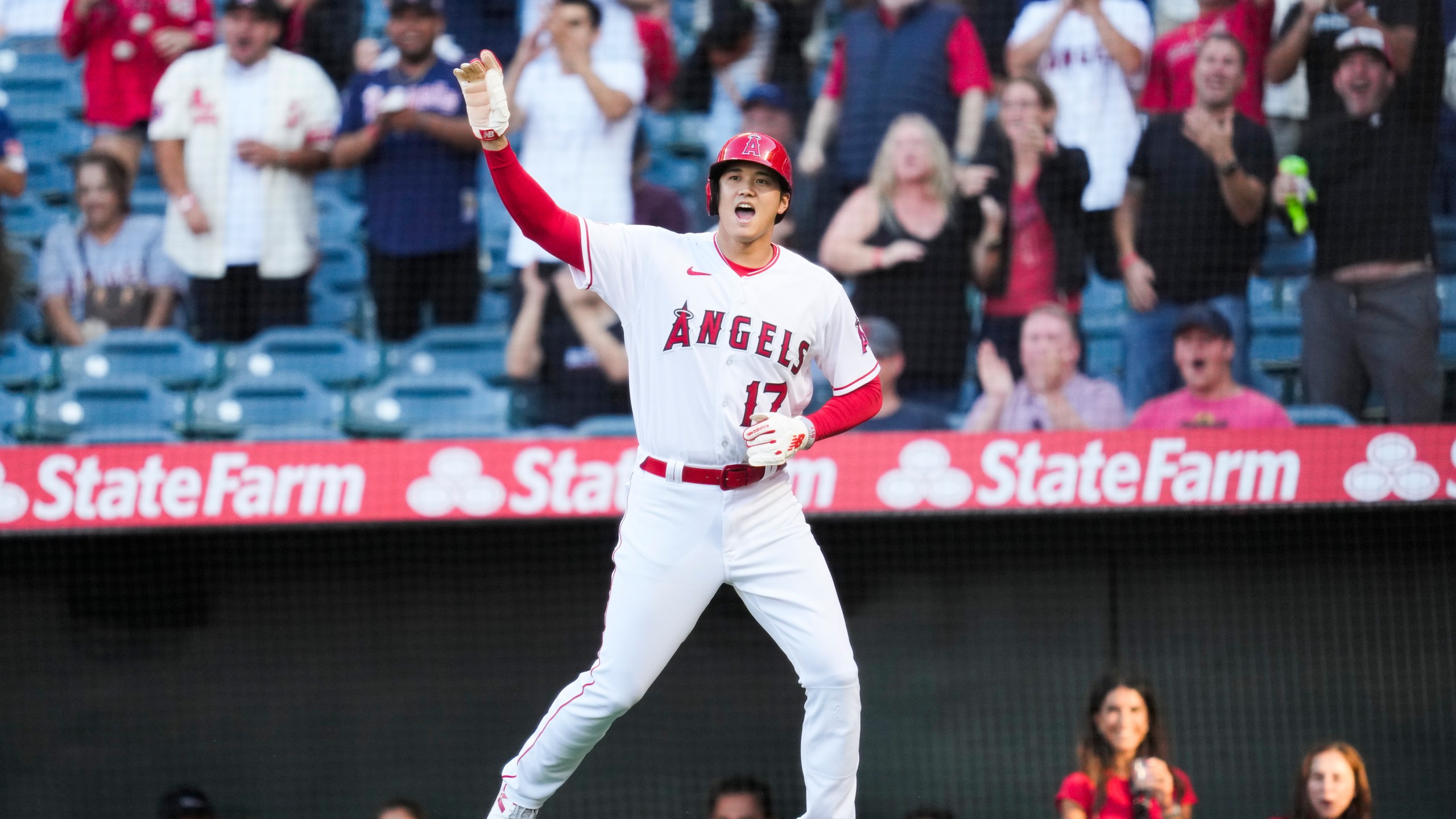 Los Angeles Angels designated hitter Shohei Ohtani (17) reacts after scoring off of a triple hit by Mike Trout during the first inning of a baseball game against the Chicago White Sox in Anaheim, Calif., Wednesday, June 28, 2023. (AP Photo/Ashley Landis)