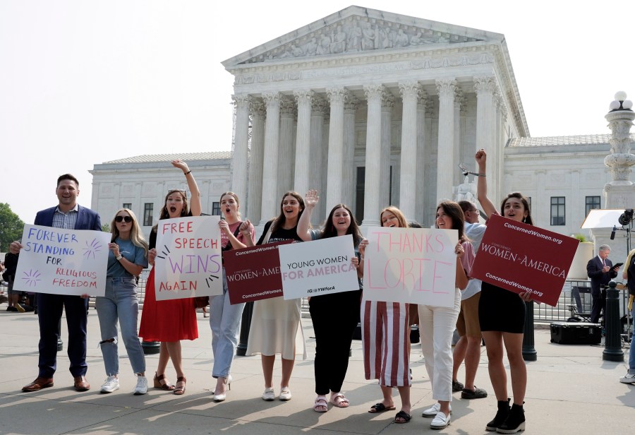 People react outside of the Supreme Court Friday, June 30, 2023, in Washington, after the Supreme Court's conservative majority ruled that a Christian graphic artist who wants to design wedding websites can refuse to work with same-sex couples. The court ruled 6-3 for designer Lorie Smith despite a Colorado law that bars discrimination based on sexual orientation, race, gender and other characteristics. Smith had argued that the law violates her free speech rights. (AP Photo/Mariam Zuhaib)