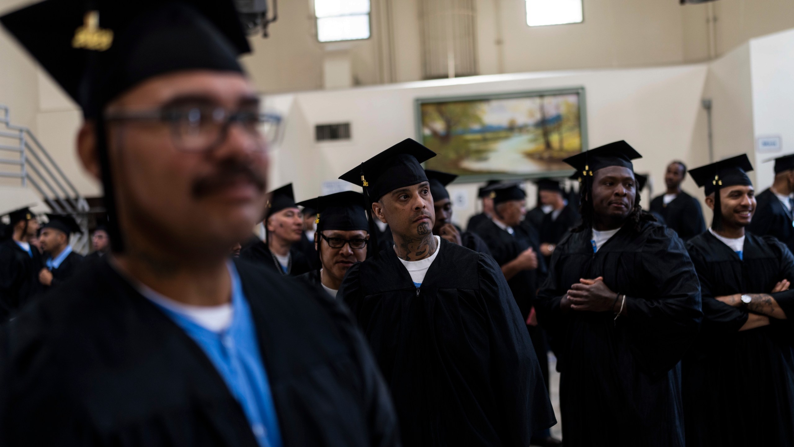 Incarcerated graduates wait for the start of their graduation ceremony