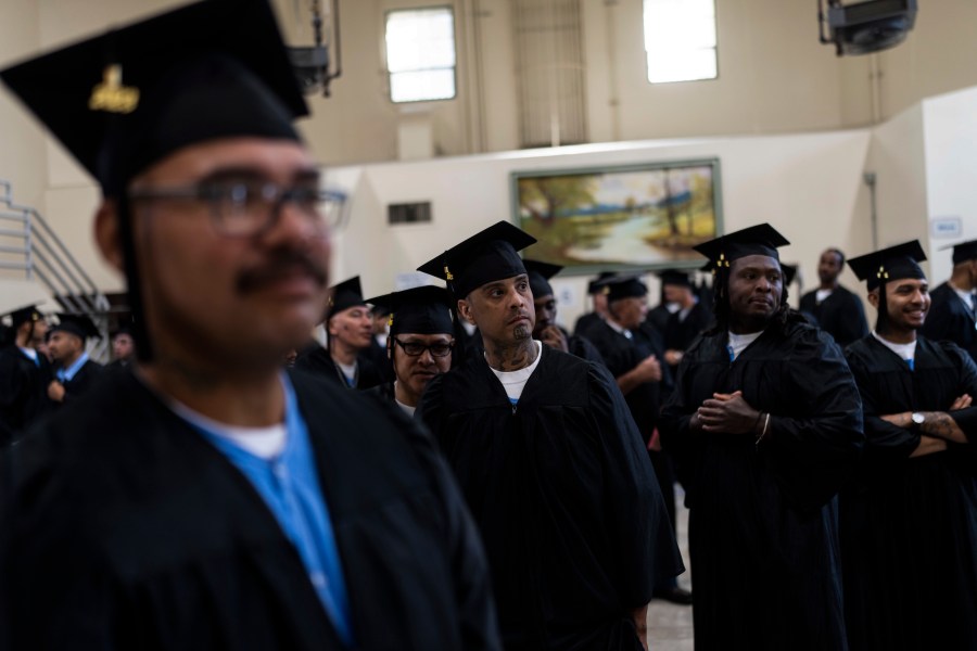 Incarcerated graduates wait for the start of their graduation ceremony