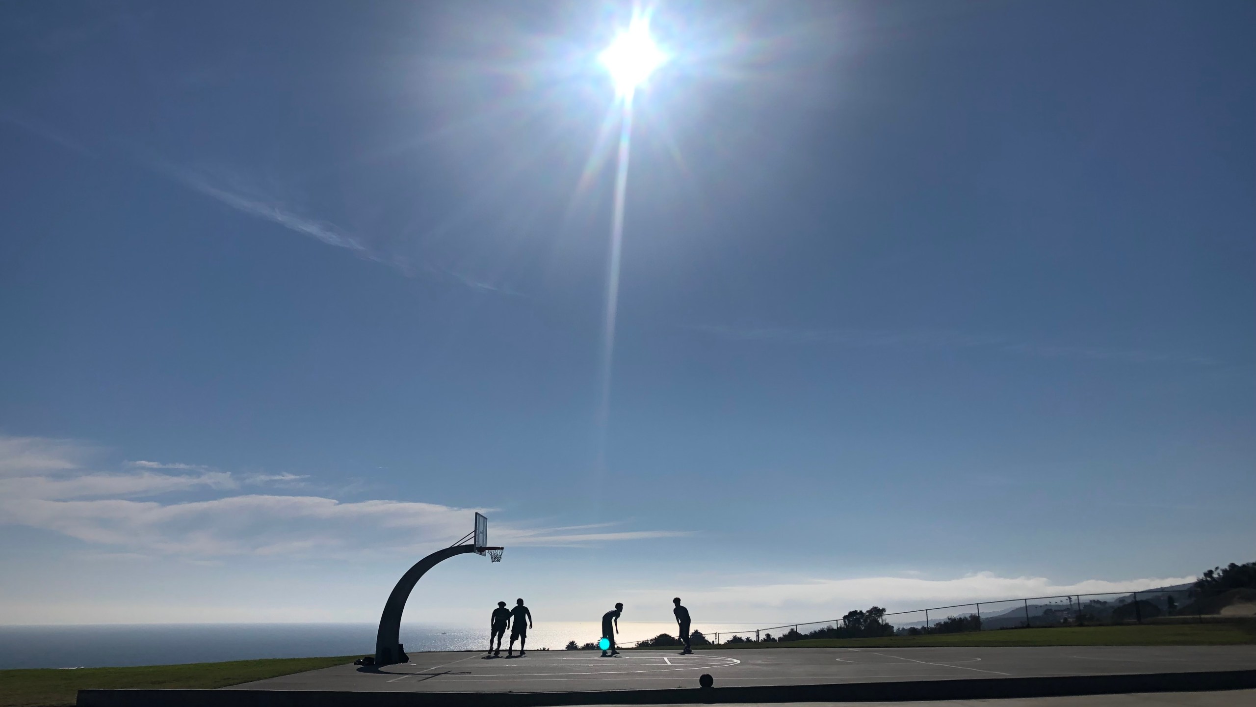 A group plays basketball on a hot summer day in San Pedro in 2021. (KTLA)