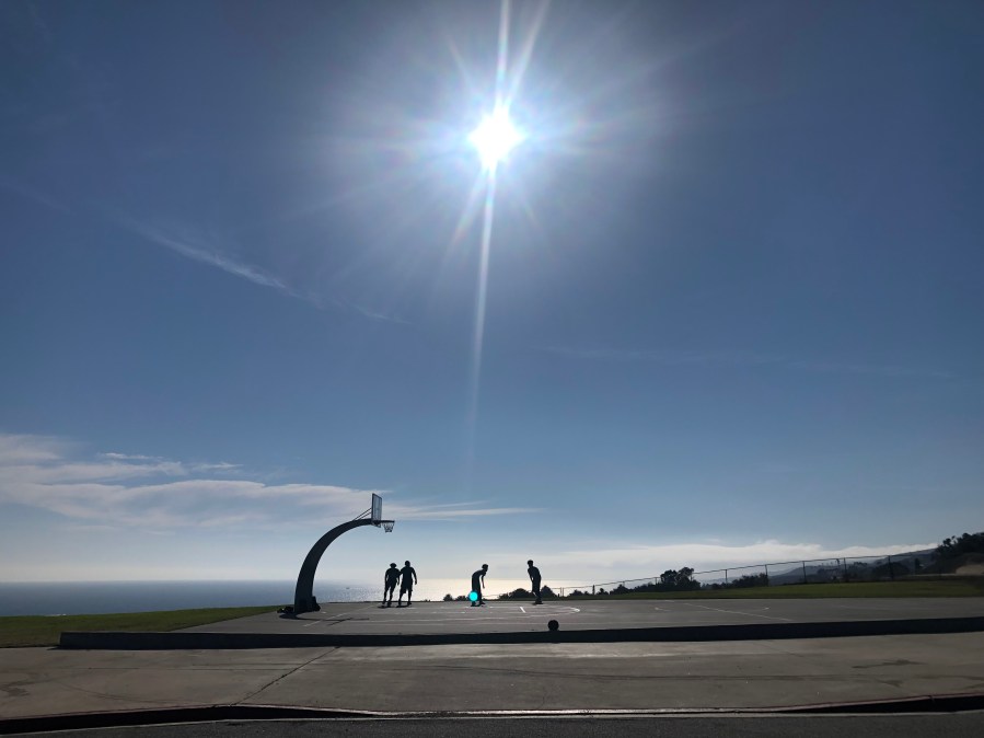 A group plays basketball on a hot summer day in San Pedro in 2021. (KTLA)