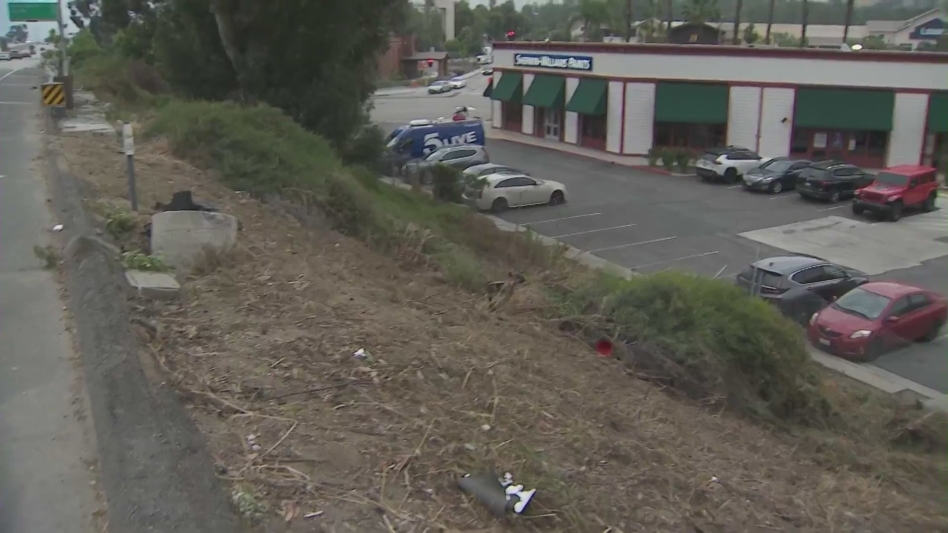 Locals are fed up with a dangerous 57 Freeway onramp in San Dimas that sees cars continually rolling over and crashing into a parking lot below. (KTLA)