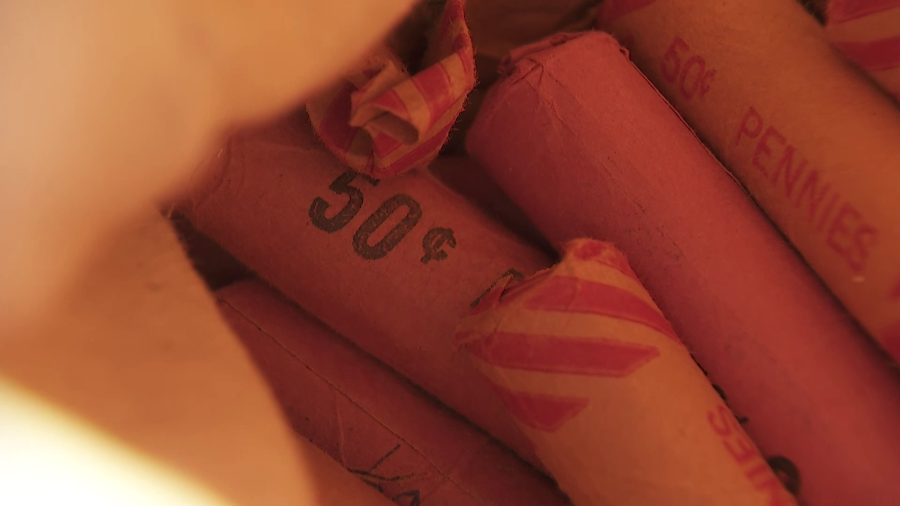 A roll of pennies is seen in the original bank roll found in a stockpile of copper coins in a South Los Angeles home. (KTLA)