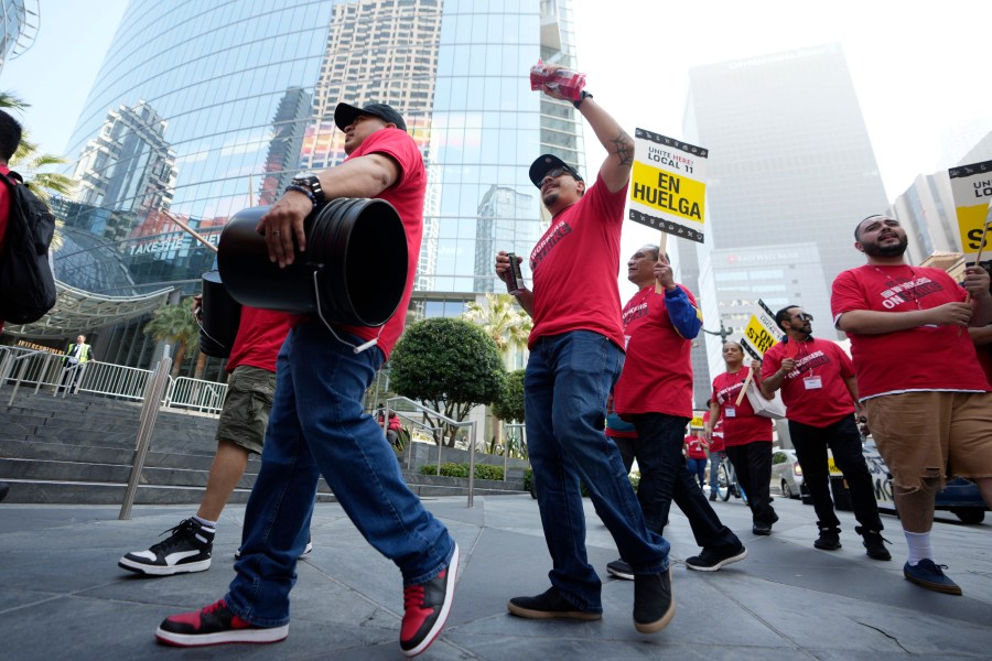 Striking hotel workers rally outside the Intercontinental Hotel after walking off their job early Sunday, July 2, 2023, in downtown Los Angeles. (AP Photo/Damian Dovarganes)