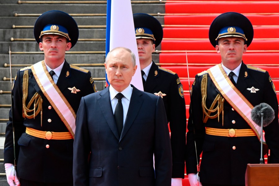 FILE - Russian President Vladimir Putin listens to the national anthem prior to delivering a speech to the units of the Russian Defense Ministry, the Russian National Guard (Rosgvardiya), the Russian Interior Ministry, the Russian Federal Security Service and the Russian Federal Guard Service, who ensured order and legality during the mutiny, at the Kremlin in Moscow, Russia, Tuesday, June 27, 2023. Russia’s rebellious mercenary chief Yevgeny Prigozhin walked free from prosecution for his June 24 armed mutiny, and it’s still unclear if anyone will face any charges in the brief uprising against the military or for the deaths of the soldiers killed in it. (Sergei Guneyev, Sputnik, Kremlin Pool Photo via AP, File)