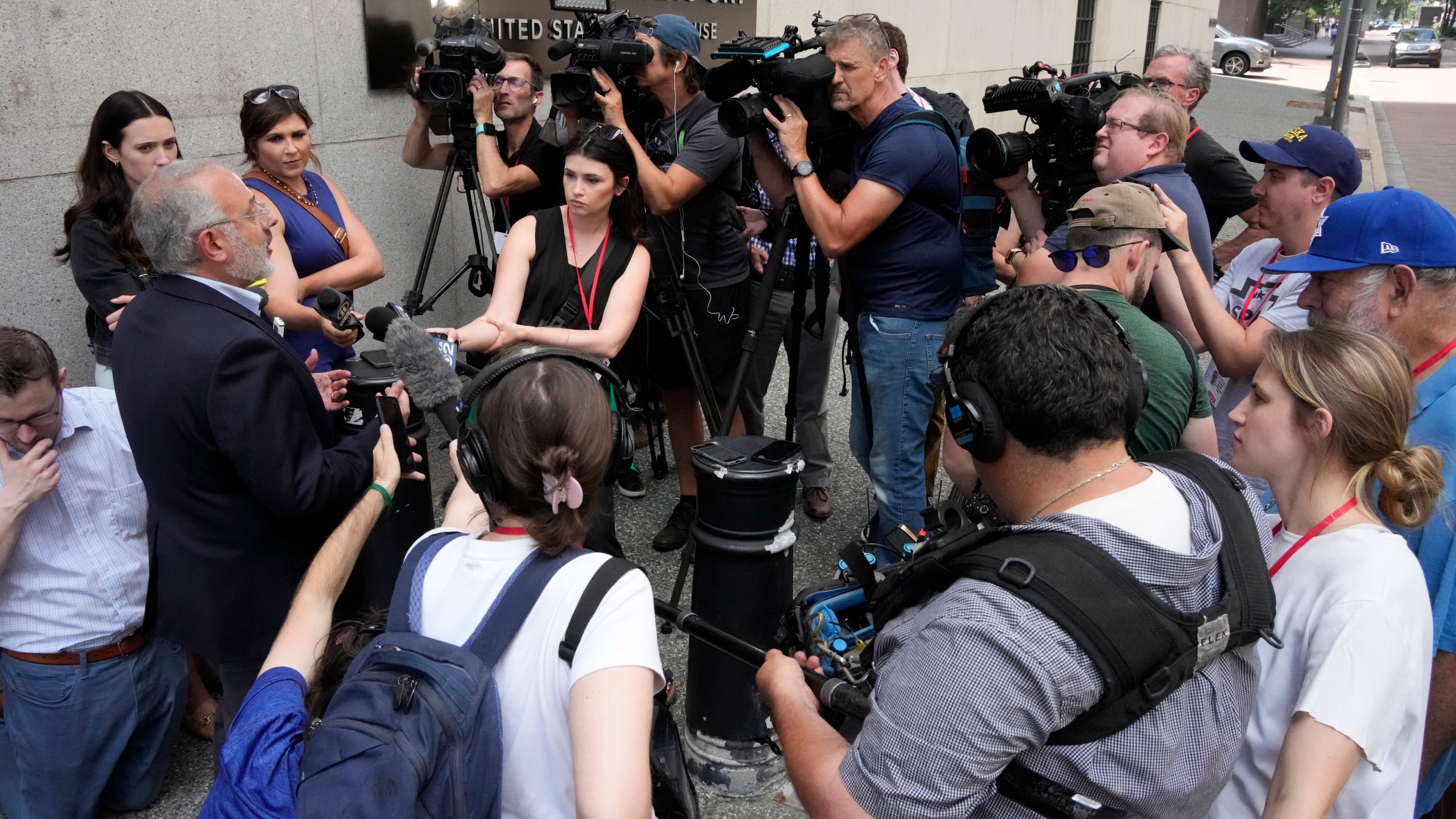 Jeffrey Finkelstein, CEO of the Jewish Federation of Pittsburgh, second from left, is surrounded by media outside the Joseph F. Weis Jr. United States Courthouse in Pittsburgh after a federal jury announced they had found Robert Bowers, who in 2018 killed 11 people at the Tree of Life synagogue in Pittsburgh, eligible for the death penalty on Thursday, July 13, 2023. (AP Photo/Gene J. Puskar)