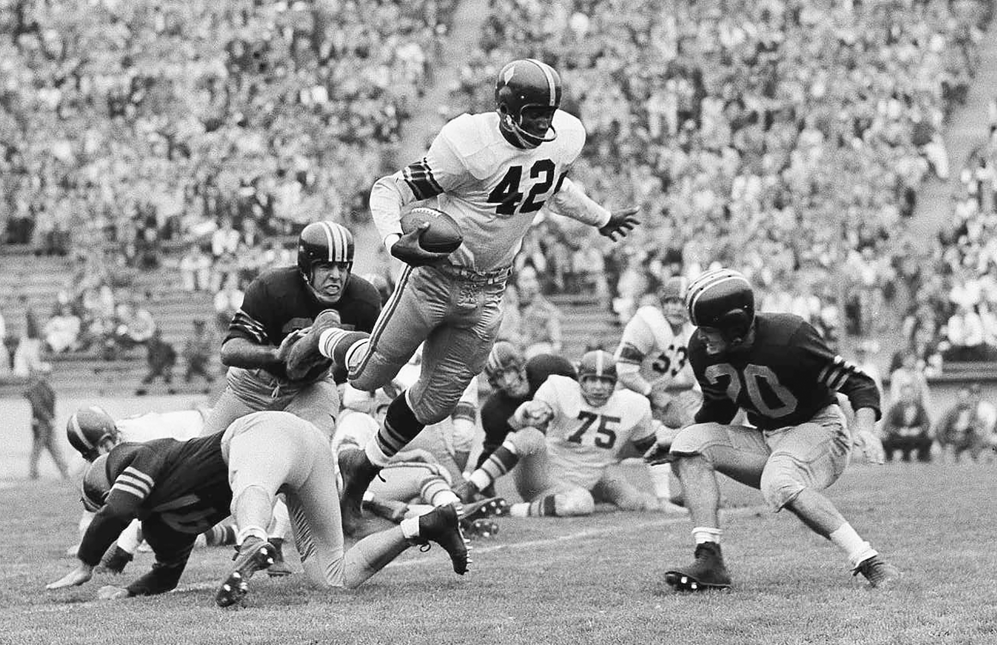 Southern California fullback C.R. Roberts (42) leaps over a California defender during the first half of a college football game Oct. 22, 1955, in Berkeley. (Clarence Hamm/Associated Press)