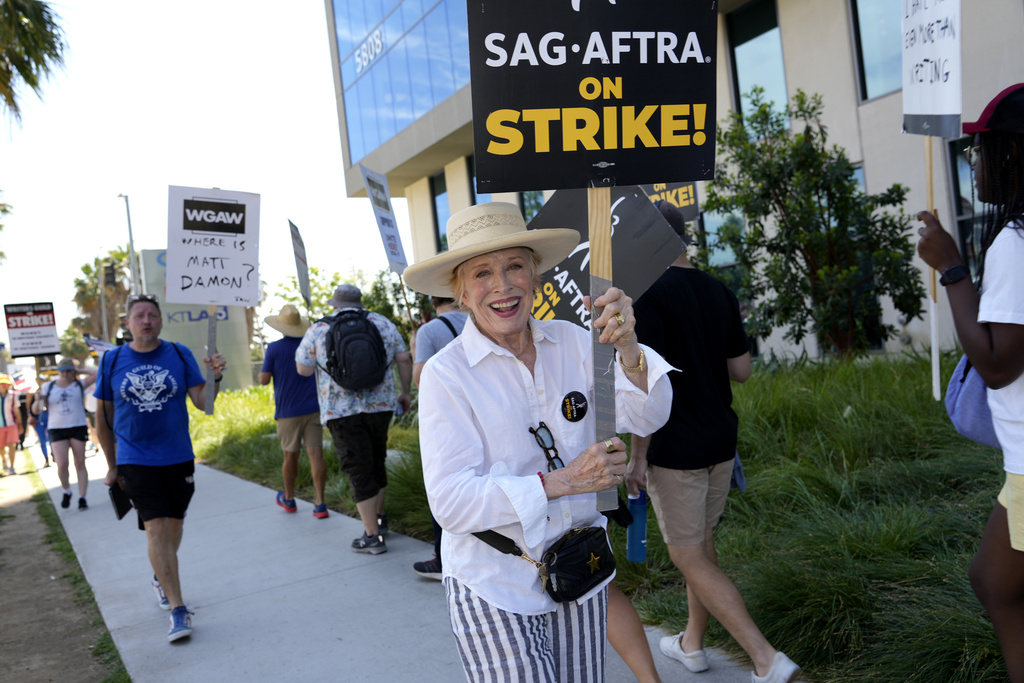 Actor Holland Taylor walks on a picket line outside Netflix studios on Wednesday, July 26, 2023, in Los Angeles. The actors strike comes more than two months after screenwriters began striking in their bid to get better pay and working conditions. (AP Photo/Chris Pizzello)