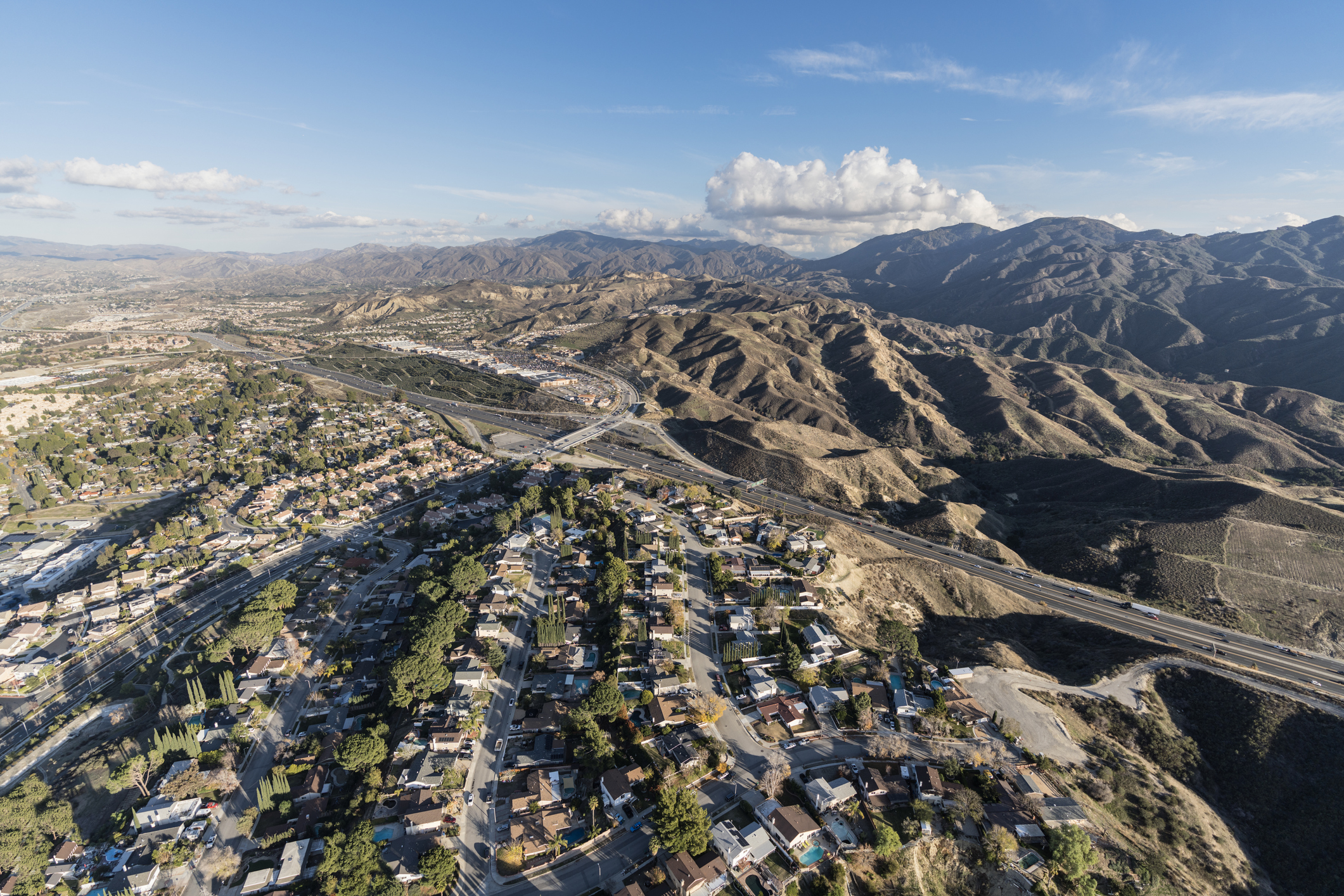 Aerial cityscape view of suburban sprawl in the Santa Clarita Valley community of Los Angeles County, California.