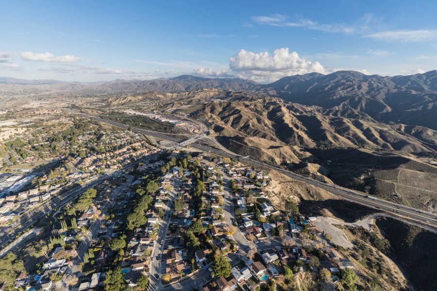 Aerial cityscape view of suburban sprawl in the Santa Clarita Valley community of Los Angeles County, California.