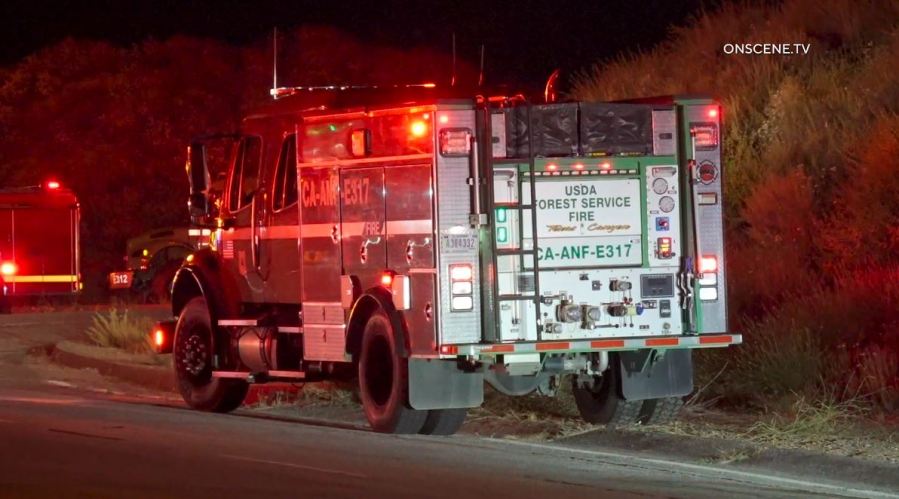 Firefighters work to extinguish the “Dry Fire,” as the flames continued spreading toward Castaic Lake on July 11, 2023. (OnScene.TV)