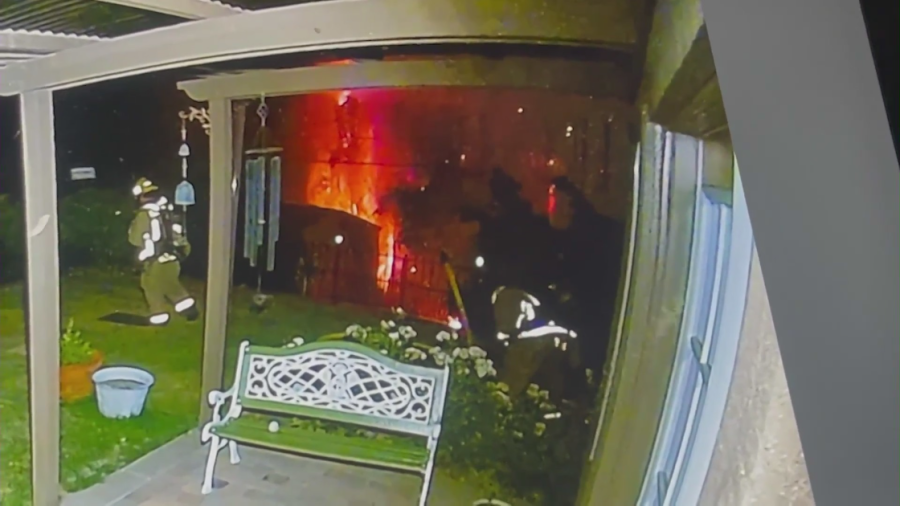 Ring video provided by Barbara Tucker shows firefighters responding to a blaze at her Corona home on July 4, 2023. (KTLA)