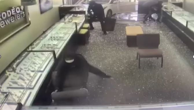 The thieves crashed through the front of the jewelry store with a car and began smashing display cases. July 1, 2023. (La Verne Police)