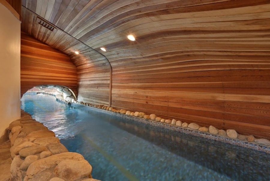 The 75-foot lap pool leads to the home's grotto, aka, the whale's tail. (Sotheby's International Realty)