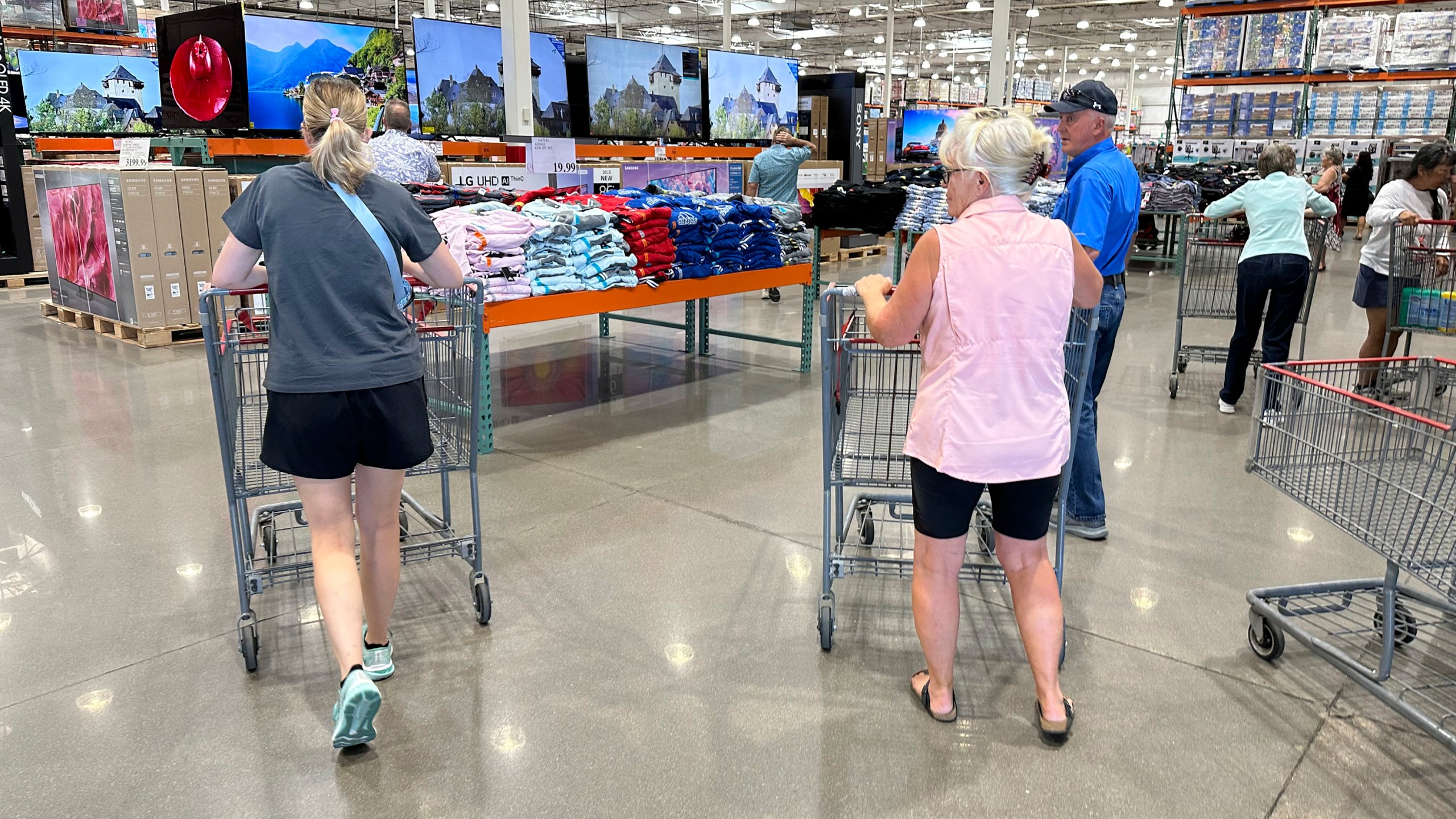 Shoppers push carts into a Costco warehouse Friday, Aug. 4, 2023, in Thornton, Colo. The stickiness of inflation could endanger the possibility that the Fed will achieve a rare "soft landing" — a scenario in which it manages to slow inflation to its target level through higher interest rates without derailing the economy.(AP Photo/David Zalubowski)