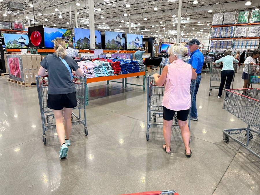 Shoppers push carts into a Costco warehouse Friday, Aug. 4, 2023, in Thornton, Colo. The stickiness of inflation could endanger the possibility that the Fed will achieve a rare "soft landing" — a scenario in which it manages to slow inflation to its target level through higher interest rates without derailing the economy.(AP Photo/David Zalubowski)