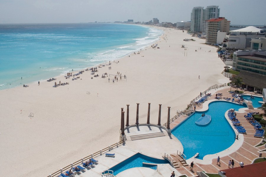 FILE - Tourists hang out on the Gaviota Azul beach in Cancun, Mexico, March 2, 2010. A four-day inspection raid targeting drugstores in Cancun, Playa del Carmen and Tulu resulted in the shuttering of 23 pharmacies at Caribbean coast resorts, six months after a report warned that the drug stores were offering foreigners pills they passed off as Oxycodone, Percocet and Adderall without prescriptions, the Navy Department said Tuesday, Aug. 8, 2023. (AP Photo/Israel Leal, File)